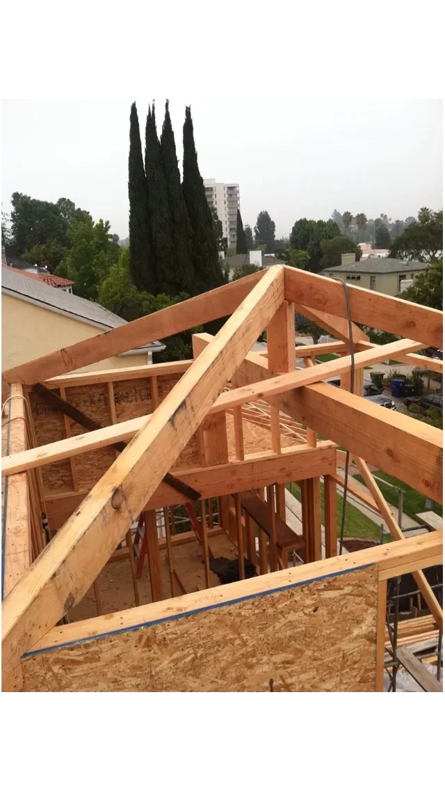 Wooden roof framing with dimensional lumber trusses and OSB sheathing during construction