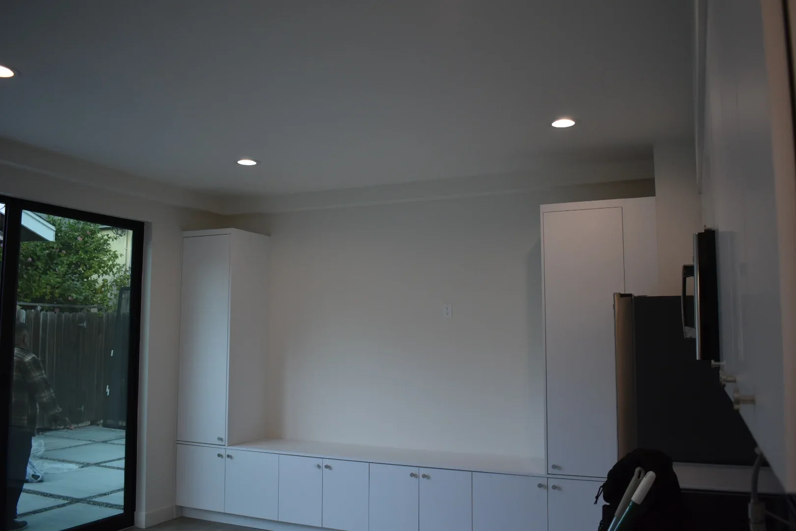 White built-in cabinetry with recessed lighting in finished garage interior