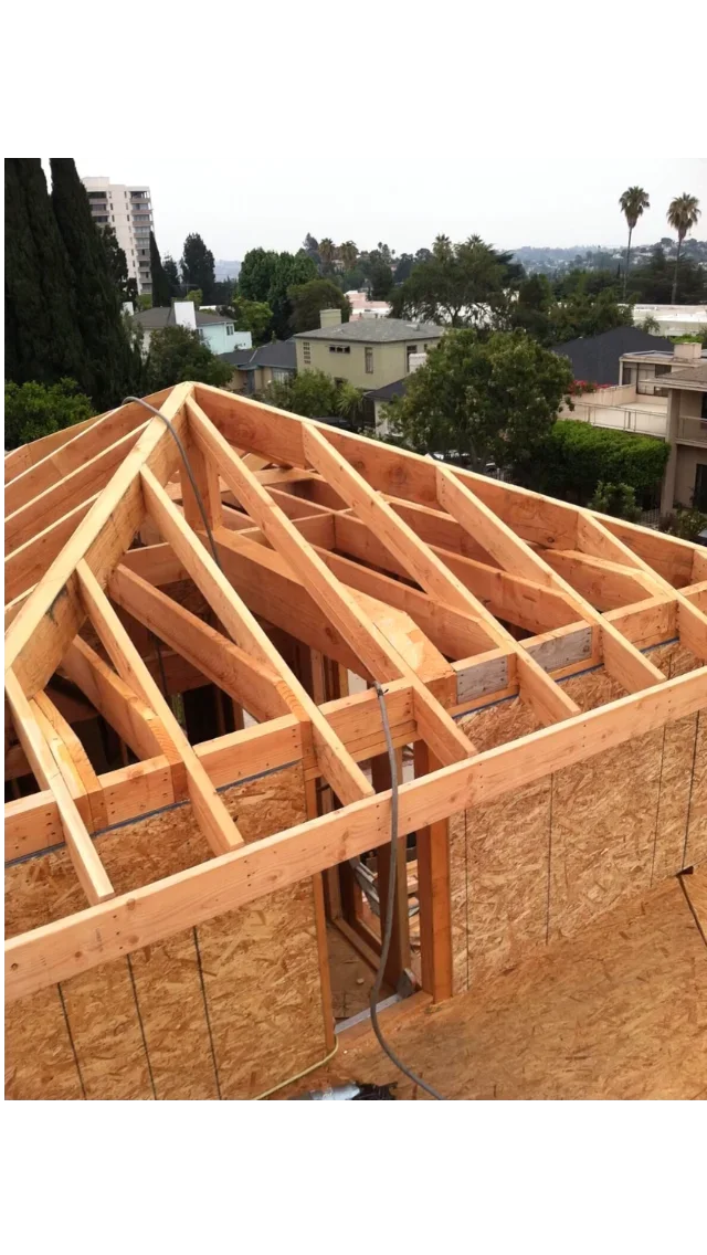 Wooden roof trusses and OSB sheathing during framing stage of residential construction