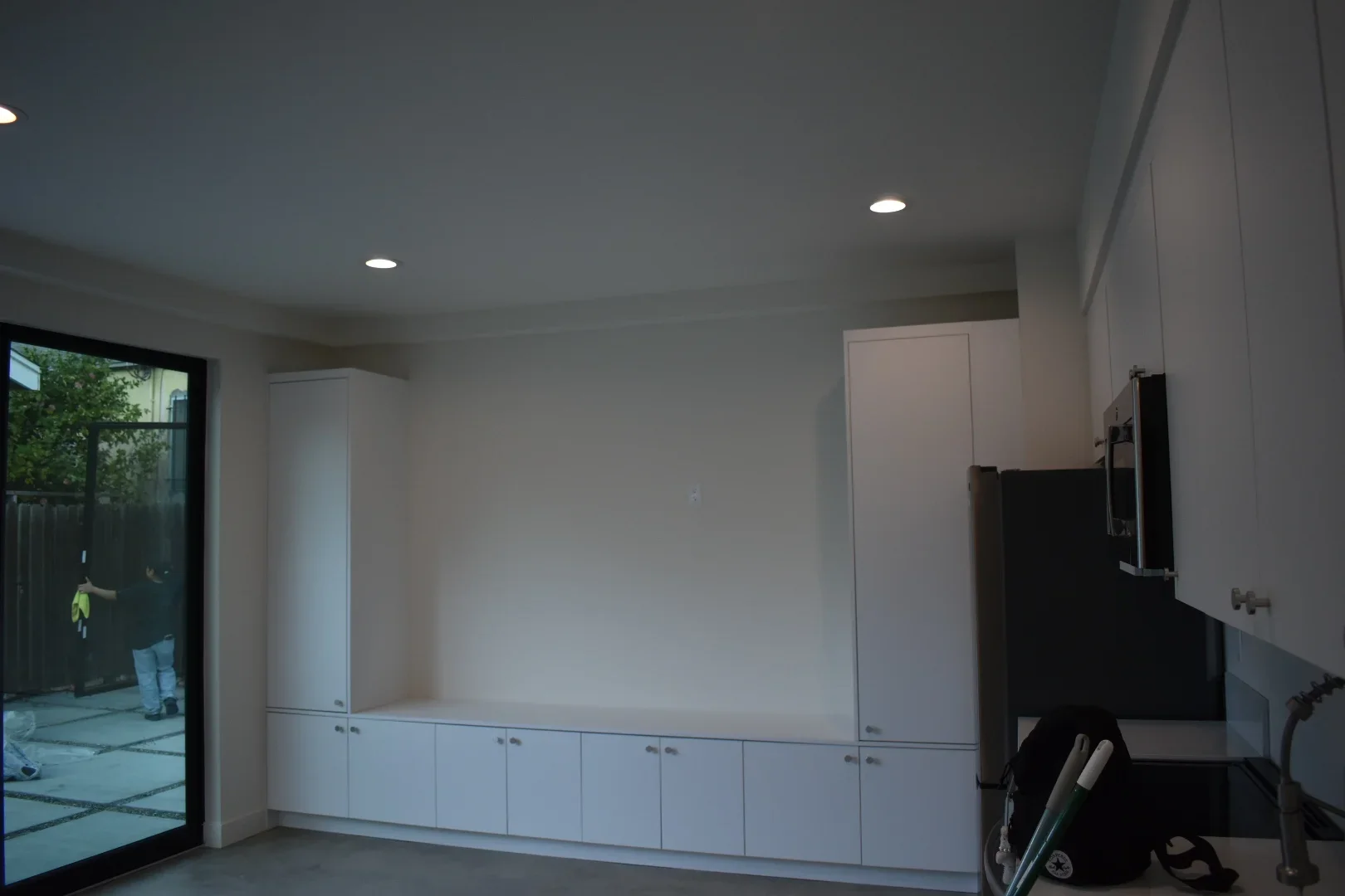 White built-in cabinetry with recessed lighting and glass patio door in mudroom